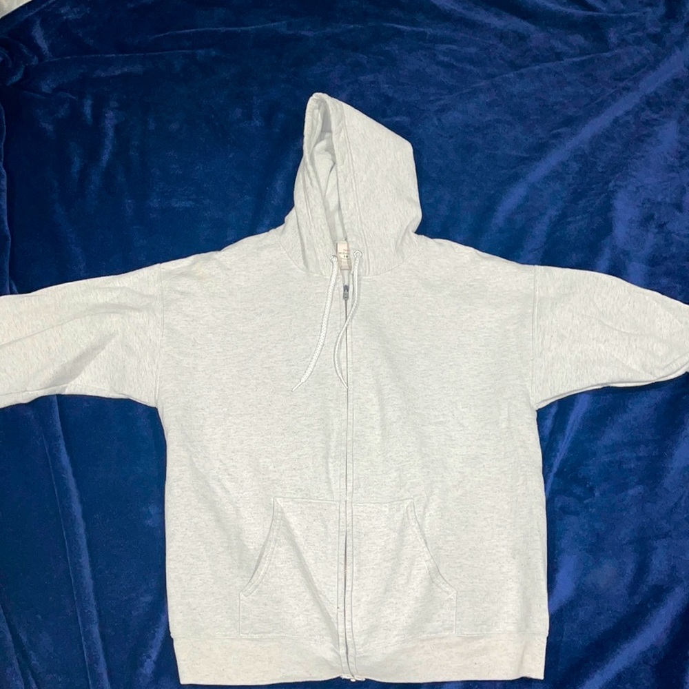 Grey/white zip up hooded sweatshirt.